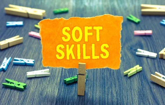 A sign with the word soft skills hanging on clothes pegs.